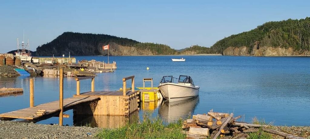 Fishing boats and wooden wharves on the calm water in Beachside